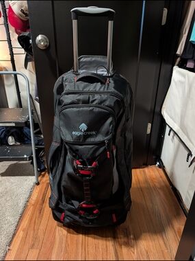 Eagle Creek Warrior Black Rolling Duffle Bag with Red Accents